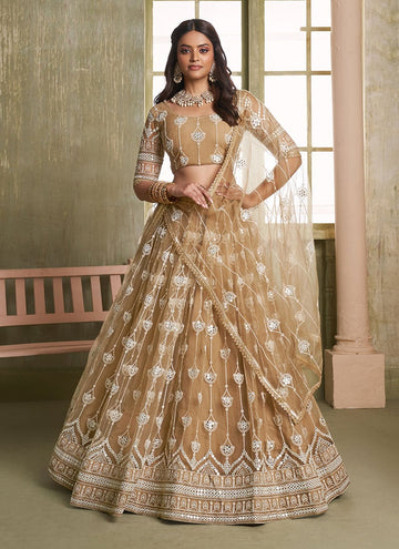 Designer Beige colored net Lehenga with sequin embroidered blouse.